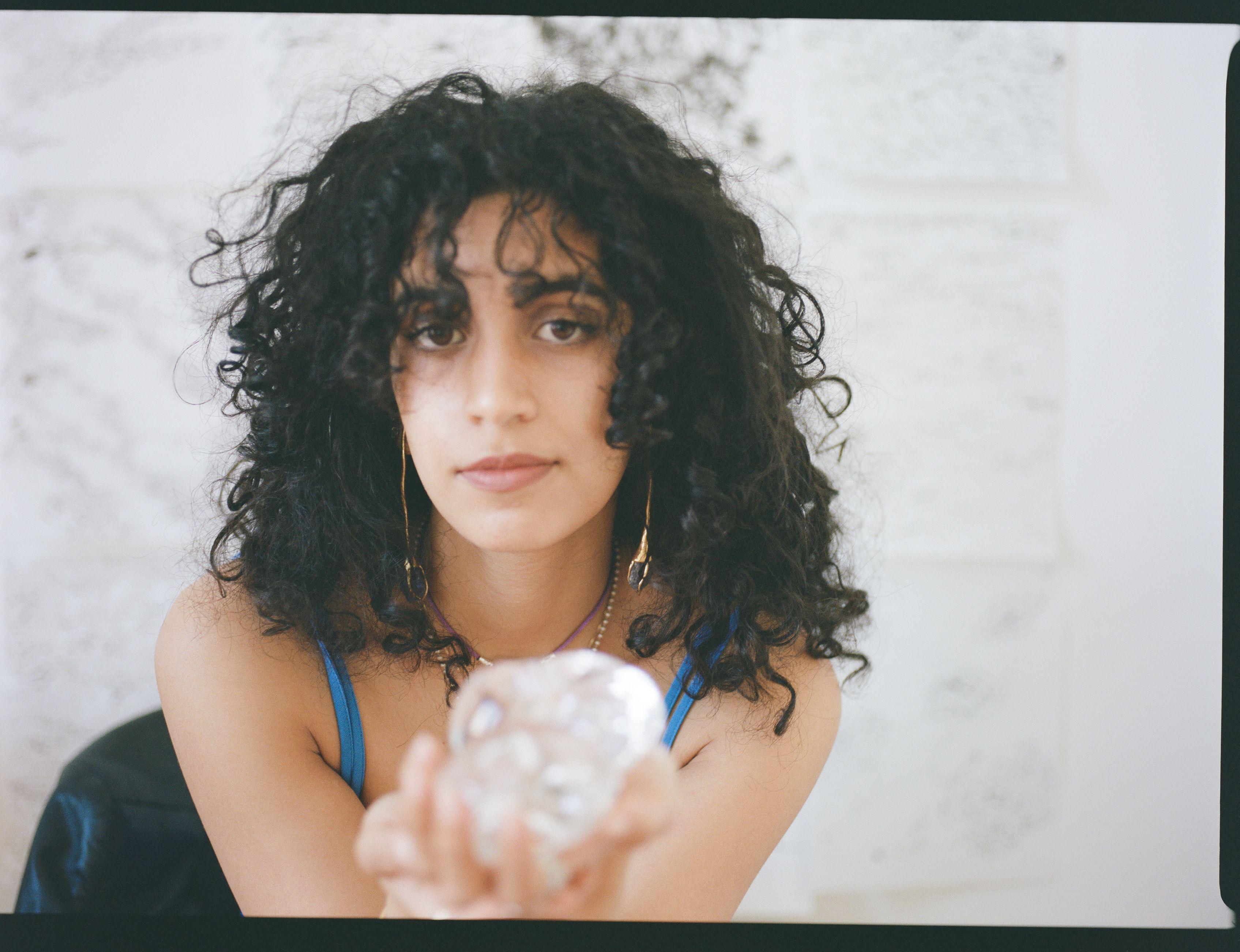 Mashael holding her glasswork