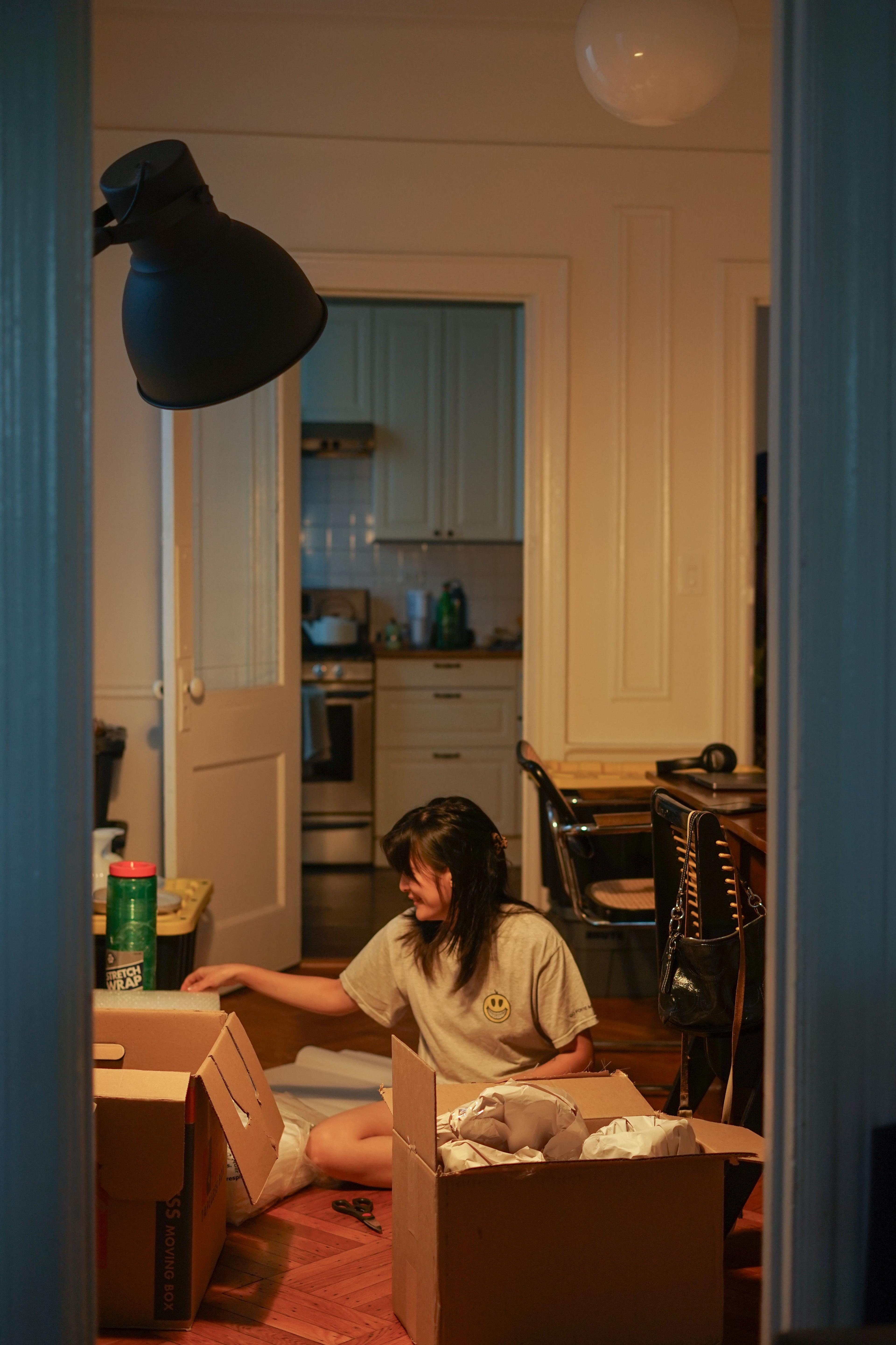 A photo of Diane packing her stuff on the floor at night